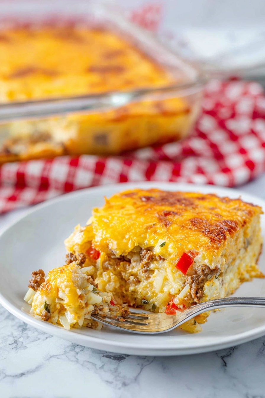 A square piece of baked casserole with three visible layers sits on a white plate on a white marbled surface. The bottom layer consists of light-colored shredded potatoes mixed with small bits of green herbs and red bell peppers. The middle layer is a mix of cooked ground meat and more shredded potatoes with some green herbs. The top layer is a golden-yellow melted cheese with slightly browned spots, creating a bubbly texture. A silver fork rests on the plate, holding a portion of the casserole. In the blurred background, a clear glass baking dish filled with the same casserole rests on a red and white checkered cloth. Photo taken with an iphone --ar 2:3 --v 7