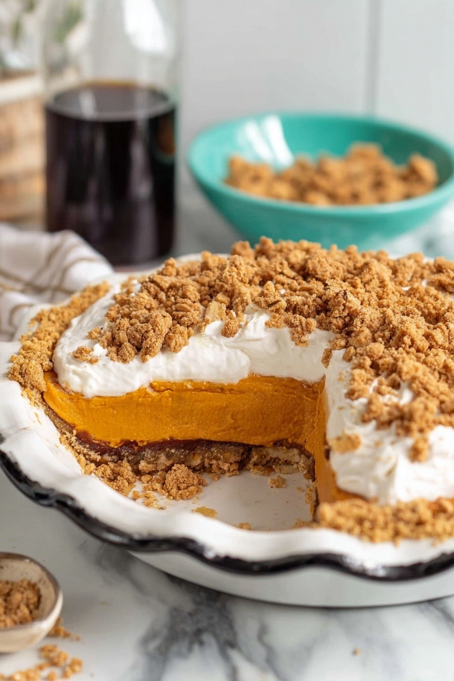 The image shows a pumpkin pie in a white pie dish with black scalloped edges. The pie has three visible layers: a crunchy golden-brown crust at the bottom, a thick, smooth orange pumpkin filling in the middle, and a thick white whipped cream layer topped with crumbled brown streusel made of oats and sugar. The pie is placed on a white marble surface. In the background, there is a clear glass bottle of dark syrup and a turquoise bowl filled with more streusel. photo taken with an iphone --ar 2:3 --v 7