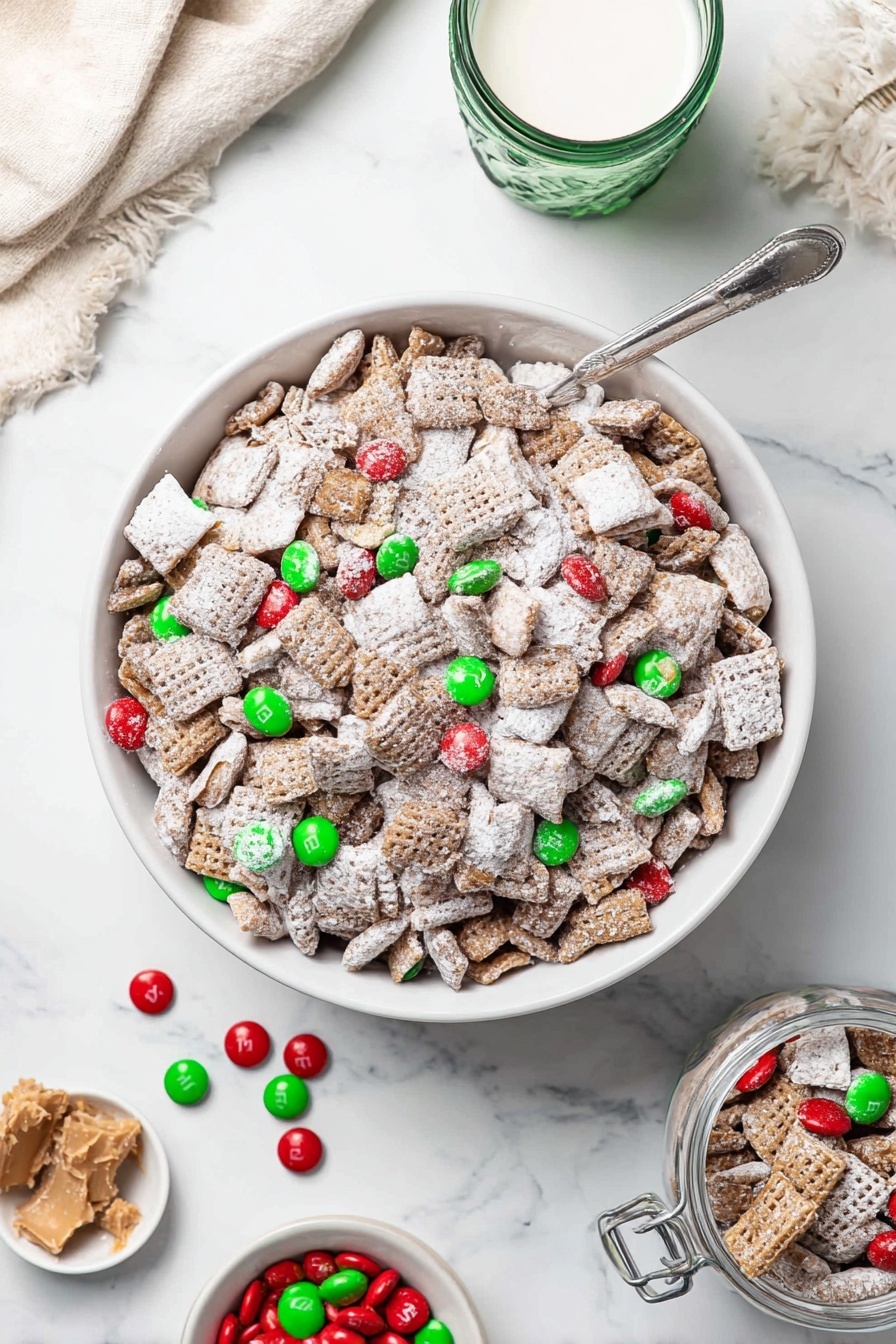 A large white bowl filled with a snack mix that has multiple layers: square and round cereal pieces covered in white powdered sugar form the main layer, mixed with small green and red candy-coated chocolates evenly spread throughout. Next to the bowl, on the white marbled surface, are scattered a few loose candies and peanut butter cup pieces. A small white bowl filled with more red and green candies and peanut butter cups is seen at the bottom right corner, and a glass jar with a metal clasp also contains the snack mix at the bottom left. In the top left, there is a green glass with milk, and a beige cloth is spread in the background. A silver spoon is partially inserted into the large bowl. Photo taken with an iphone --ar 2:3 --v 7
