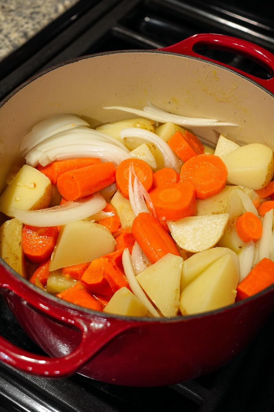 A white plate on a white marbled surface holds a layered meal with three main parts: at the bottom, there is a bed of white rice sprinkled lightly with black sesame seeds; on top of the rice lays a golden-brown crispy fried chicken cut into thick slices and garnished with chopped green onions; beside that, the third layer is a bright yellow curry sauce filled with visible chunks of soft potatoes, orange carrot slices, and translucent onion pieces, all glistening under the light. photo taken with an iphone --ar 2:3 --v 7