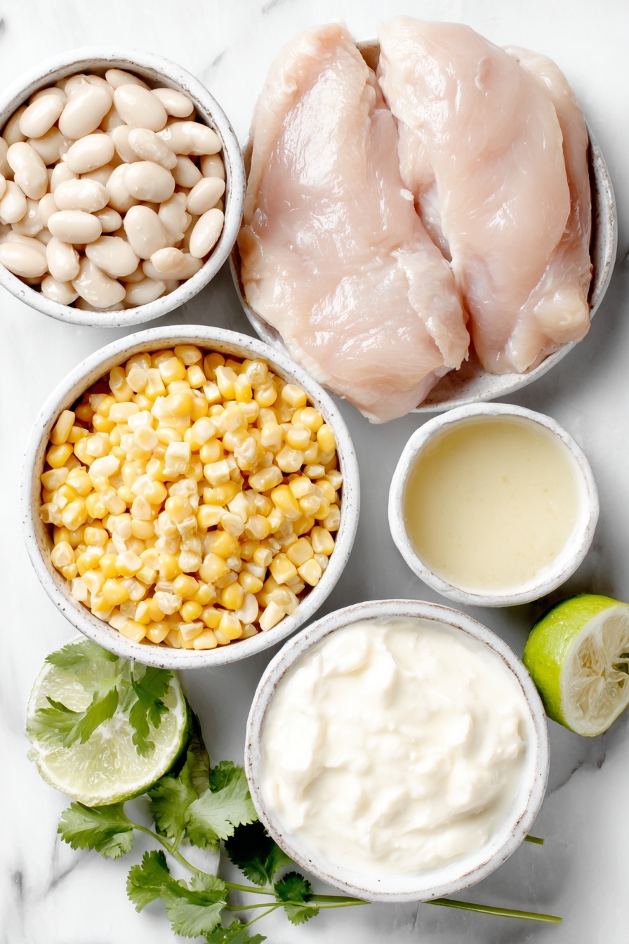 Flat lay of a small chopped white onion, two white ceramic bowls—one with drained white cannellini beans, one with fresh yellow corn kernels, a small white bowl of pale chicken broth, a small white bowl of diced green chilies, whole raw boneless skinless chicken breasts, a small bunch of bright green cilantro, a small white bowl of creamy white Greek yogurt, a small white bowl with smooth cream cheese block, a whole fresh lime, placed on a clean white marble surface, soft natural light, photo taken with an iPhone, professional food photography style, fresh ingredients, white ceramic bowls, no bottles, no duplicates, no utensils, no packaging --ar 2:3 --v 7 --p m7354615311229779997