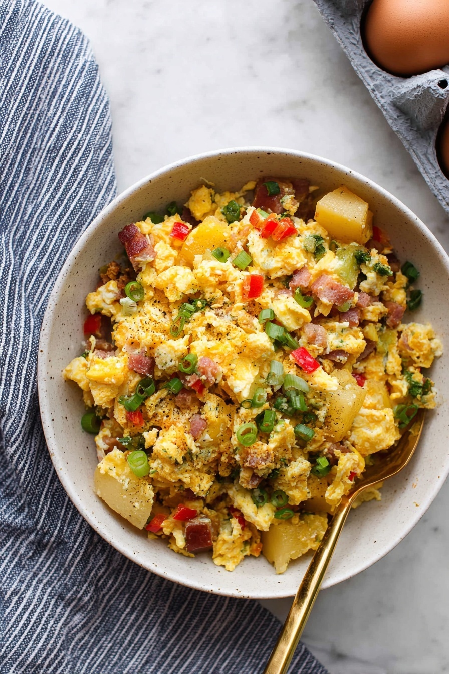 A clear glass bowl holds seven separate layers of ingredients arranged side by side without mixing. Starting from the top left, there are finely chopped white onions, next to small diced bright red bell peppers, then finely chopped green bell peppers. Below the green peppers are small white cubes of cheese, and next to them on the right are small pink cubes of ham. At the bottom left, there is a pile of shredded orange cheddar cheese, and next to it on the left side is a layer of browned crumbled sausage. The bowl is placed on a white marbled texture surface. Photo taken with an iphone --ar 2:3 --v 7